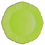 Green plate with scalloped edge on a white background